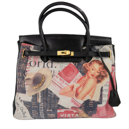 A structured black leather handbag with a vintage-style collage print on the front panel, featuring a gold-tone turn-lock closure and dual top handles, photographed against a white background.